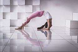 Pilates with back arch position in a photo studio, Moscow